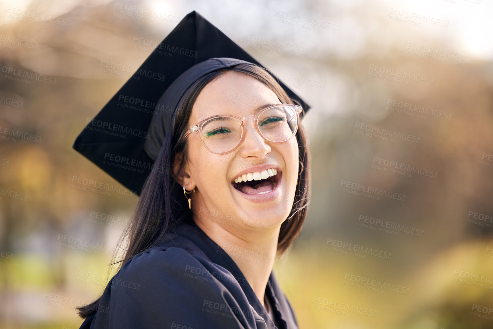 Buy stock photo Woman, outdoor portrait and excited for graduation with celebration, scholarship and support for college success. Happy, glasses and face of female graduate in campus for education and achievement