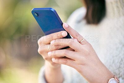 Buy stock photo Hands, phone or girl in nature to chat on social media, internet post or news website notification in park. Outdoor, closeup or woman of texting, networking or typing online on blog or mobile app