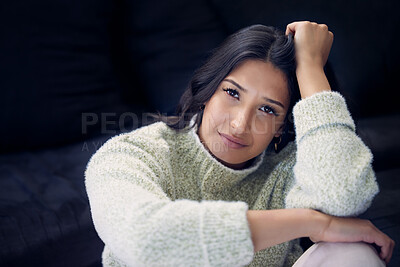 Buy stock photo Shot of a young woman looking depressed at home