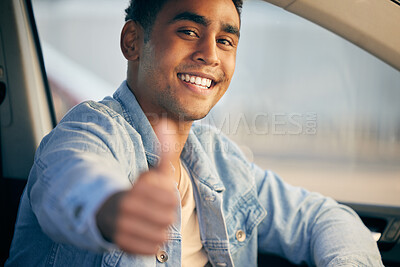 Buy stock photo Shot of a young man showing thumbs up while traveling in a car