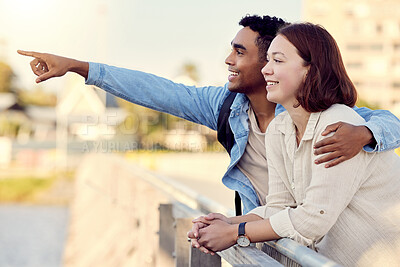 Buy stock photo Shot of a young couple exploring a city together