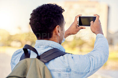 Buy stock photo Shot of a man taking pictures while out in the city