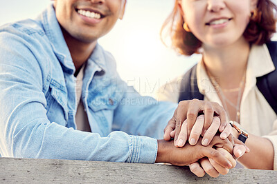 Buy stock photo Cropped shot of a young couple holding hands while standing outside