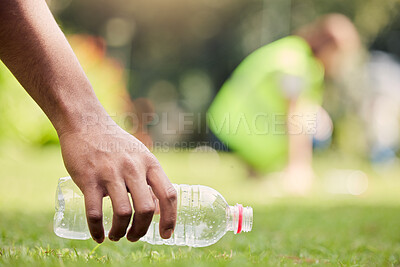 Buy stock photo Shot of an unrecognisable person picking up litter at a park