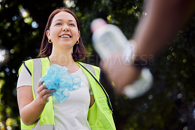 Buy stock photo Shot of a young woman picking up litter at a park
