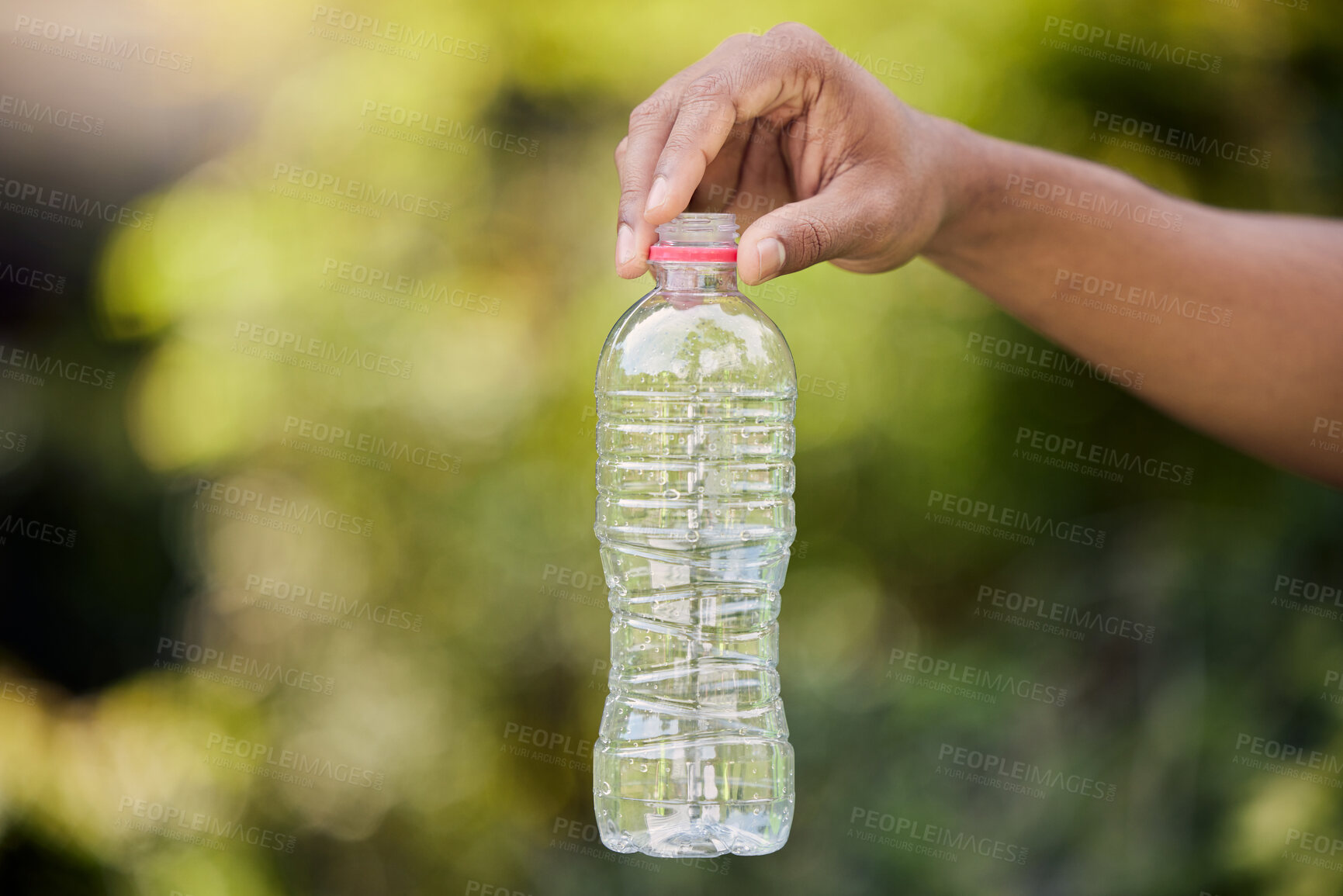 Buy stock photo Volunteer, hand and bottle or cleaning park, community service and recycle for climate change or saving nature. Person, charity or plastic with eco friendly action, support and environmental care