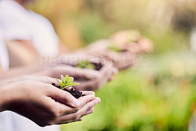 Buy stock photo Shot of a group of unrecognisable people holding plants growing out of soil