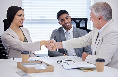 Buy stock photo Shot of businesspeople shaking hands during a meeting in a modern office