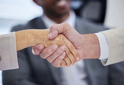 Buy stock photo Shot of unrecognisable businesspeople shaking hands in a modern office