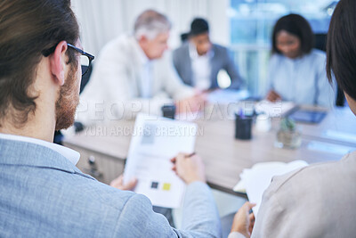 Buy stock photo Shot of two people looking at a document while in the boardroom