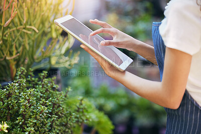 Buy stock photo Shot of a nursery owner using her digital tablet