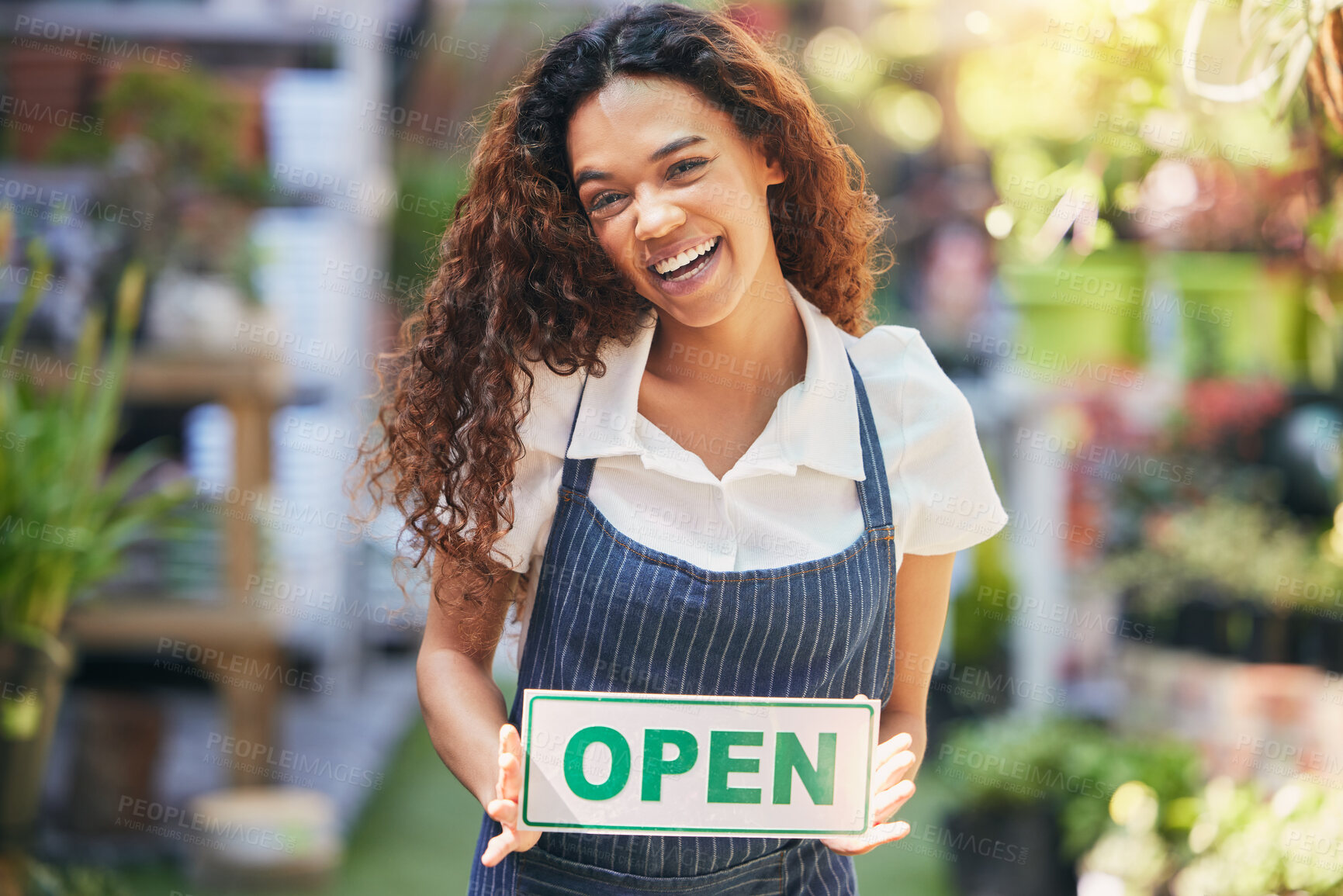 Buy stock photo Shot of a business owner holding an open sign