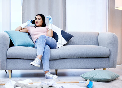 Buy stock photo Woman, phone call and cleaning on sofa and gossip, communication and relax on couch of house. Smartphone, housewife and talking for virtual conversation, dirty and messy home living room and chores
