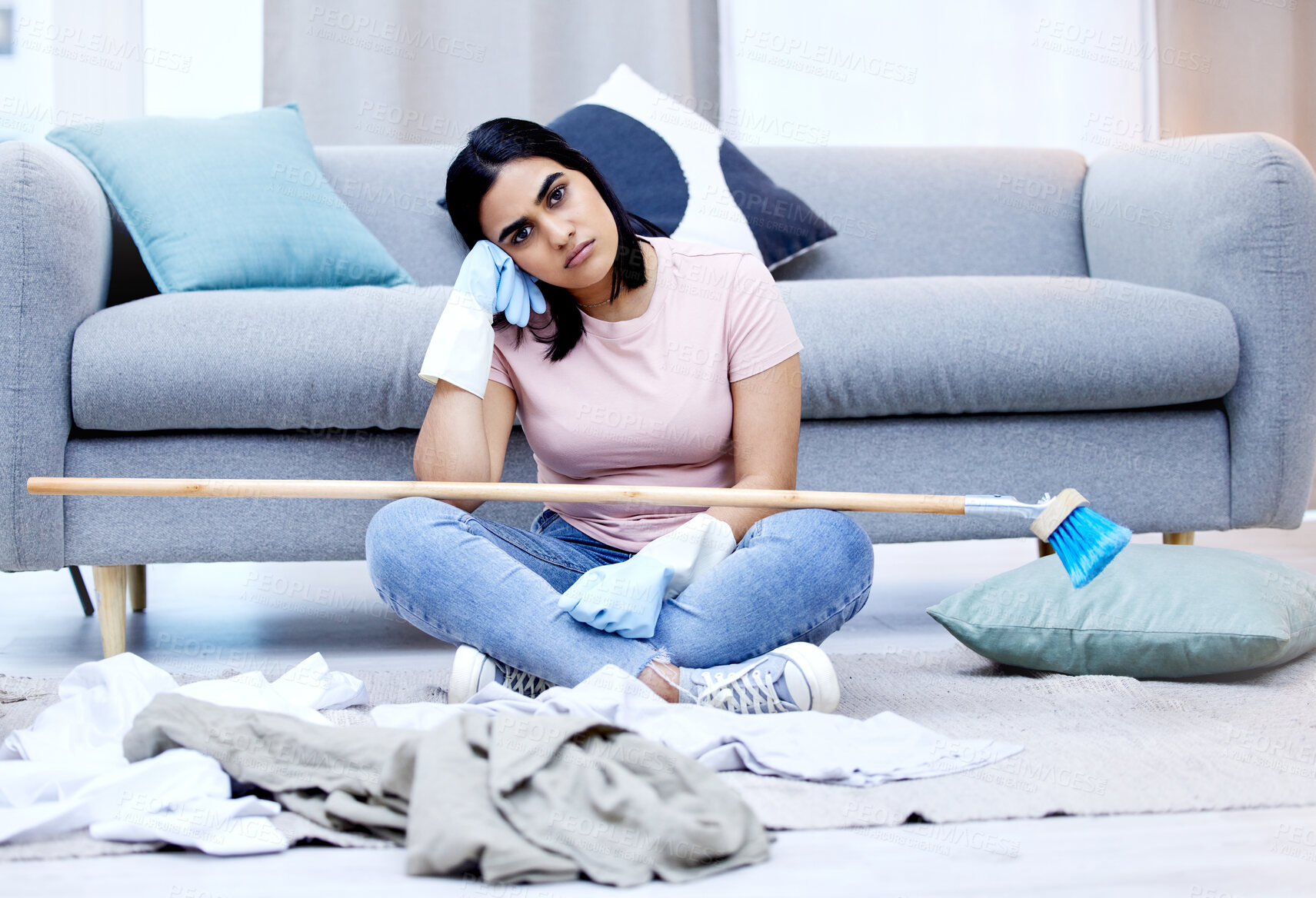Buy stock photo Bored, woman and portrait in living room for cleaning in house with dirty clothes, sweeping and broom. Annoyed, frustrated and moody from housework in home with exhausted, fatigue and lounge.