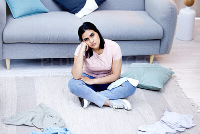 Buy stock photo Shot of a young woman taking a break from chores at home