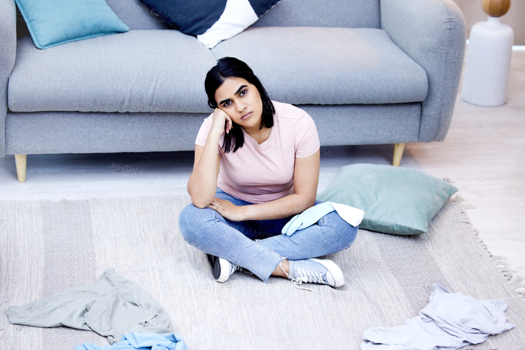 Buy stock photo Woman, clothes and portrait on messy floor with tired, house work and laundry in apartment. Frustrated female cleaner, burnout and fatigue in living room for cleaning chaos with stress and overworked