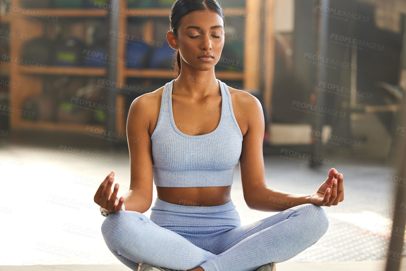 Buy stock photo Meditation, yoga and Indian woman in gym for mindfulness, wellness and breathing exercise on floor. Mental health, meditate and female person in lotus pose for mindset, zen and balance in training
