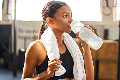 Buy stock photo Tired, fitness or Indian woman drinking water at gym in training, workout or exercise to hydrate her body. Fatigue, wellness or thirsty girl with bottle for healthy liquid hydration on resting break