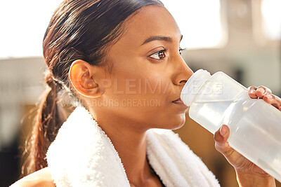 Buy stock photo Thirsty, fitness or Indian woman drinking water at gym in training, workout or exercise to hydrate her body. Fatigue, face or tired girl with bottle for healthy liquid hydration on resting break 