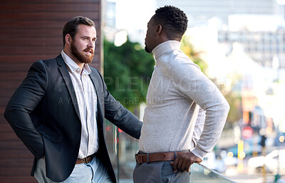 Buy stock photo Shot of two co workers having a conversation on their office balcony