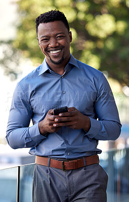 Buy stock photo Shot of a young businessman using his smartphone to send a text message