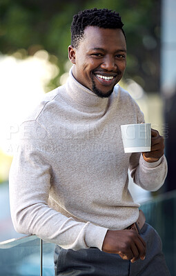 Buy stock photo Shot of a young businessman enjoying a cup of coffee on his work balcony