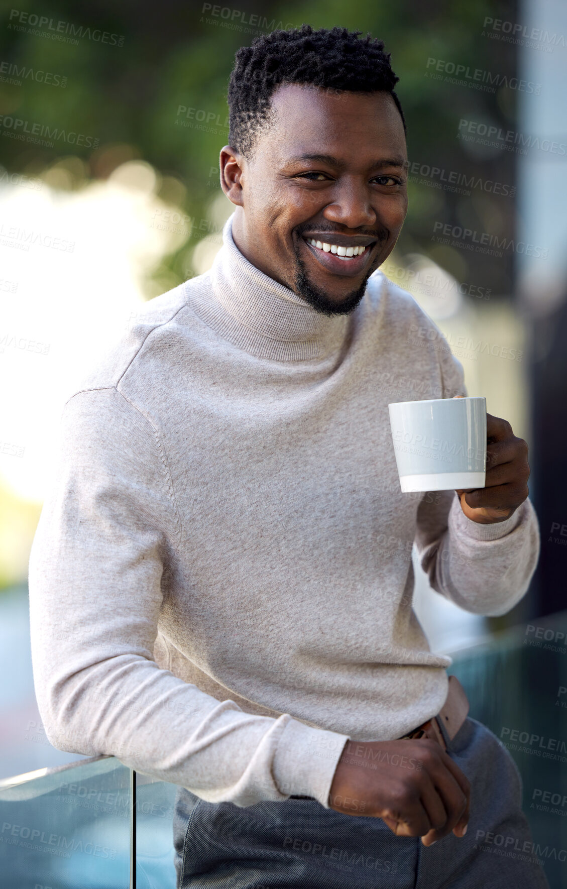 Buy stock photo Shot of a young businessman enjoying a cup of coffee on his work balcony