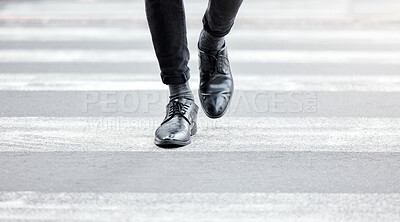 Buy stock photo Shot of an unrecognizable businessman crossing the street in the city