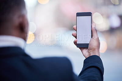 Buy stock photo Shot of an unrecognizable businessman using a phone in the city