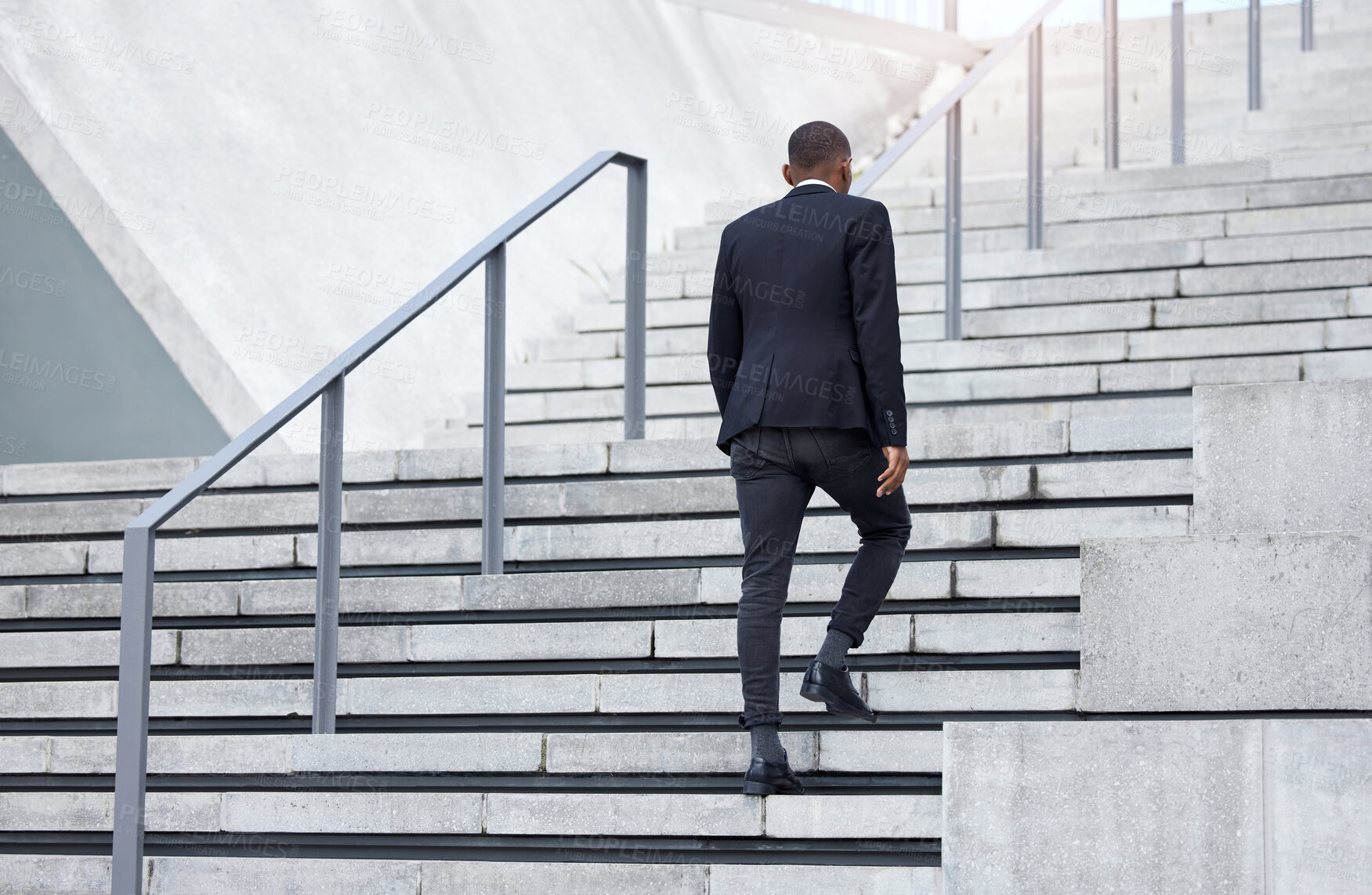 Buy stock photo Shot of an unrecognizable businessman walking up stairs in the city