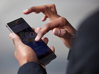 Buy stock photo Shot of an unrecognizable businessman using a phone in the city