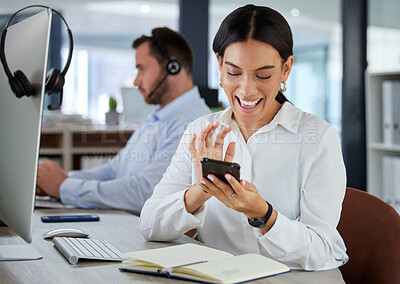 Buy stock photo Shot of a young woman using a smartphone in a modern call centre