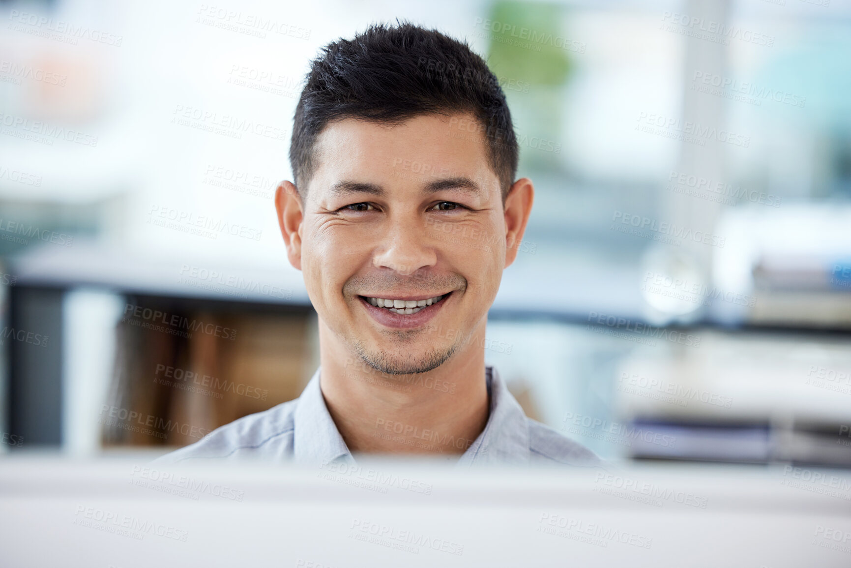 Buy stock photo Portrait of a young businessman working on a computer in an office