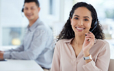 Buy stock photo Portrait of a young call centre agent working in an office with her colleague in the background