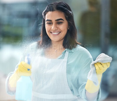 Buy stock photo Indian, woman and cleaning or window with spray bottle in home, soap and cloth for hygiene. Female cleaner or worker with container or towel for washing, hospitality with happiness at hotel or house