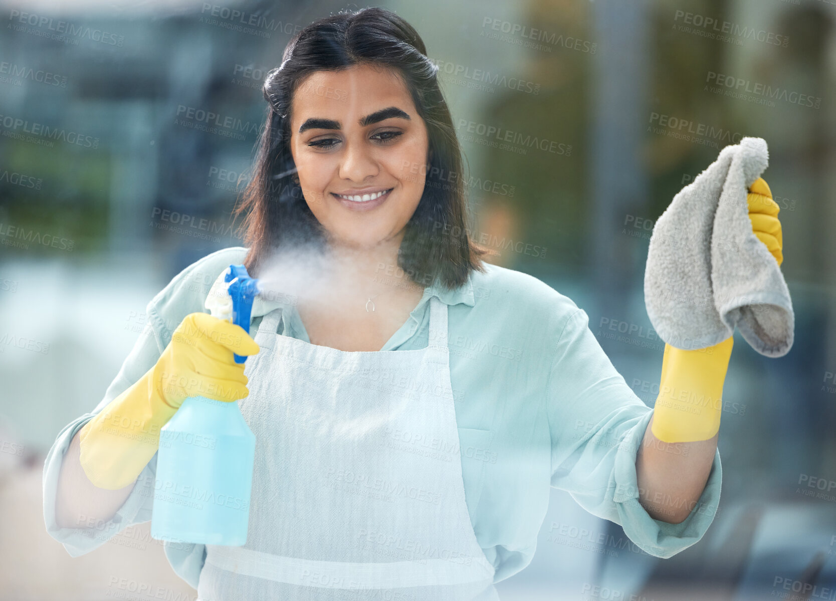 Buy stock photo Indian, woman and cleaning or glass with spray bottle in home, soap and cloth for hygiene. Female cleaner or worker with container or towel for washing, hospitality with happiness at hotel or house