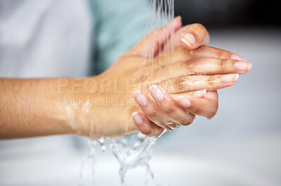 Buy stock photo Water, woman and wash hands in bathroom for hygiene, germ protection and cleaning with liquid for wellbeing. Tap, skincare and safety from bacteria, virus and splash at sink for healthcare routine