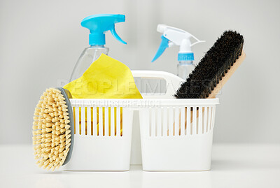 Buy stock photo Table, brush or basket with supplies, spray bottle or chemical for bacteria, wellness or dirty mess in home. Grey background, cleaning service or ready for washing with product, liquid soap or gloves