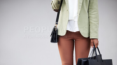 Buy stock photo Shot of a woman holding shopping bags against a studio background