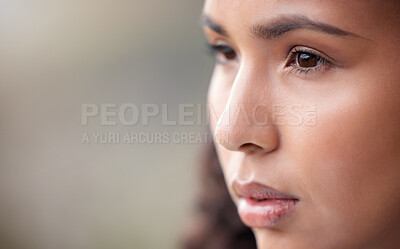 Buy stock photo Closeup shot of a beautiful young woman looking thoughtful while standing outside