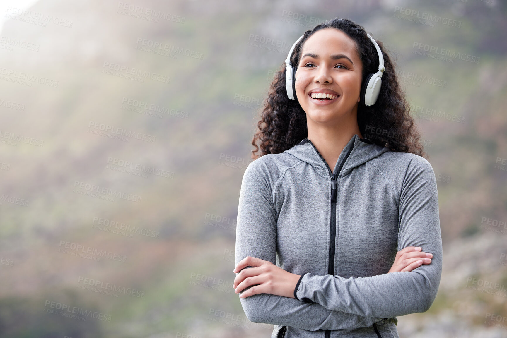 Buy stock photo Mountains, headphones and woman with arms crossed, fitness and exercise with wellness, smile and streaming music. Person, girl or runner with headset, progress and outdoor for workout, audio or sound