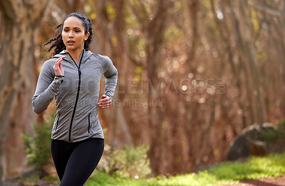 Buy stock photo Woman, running and thinking in nature for exercise, fitness and wellness in forest. Brazilian runner, training and workout by jogging for cardio, commitment and goals or challenge in woods in morning