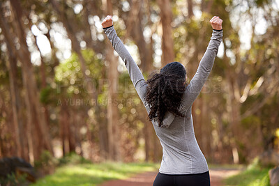 Buy stock photo Shot of a fit young woman looking cheerful while out for a run