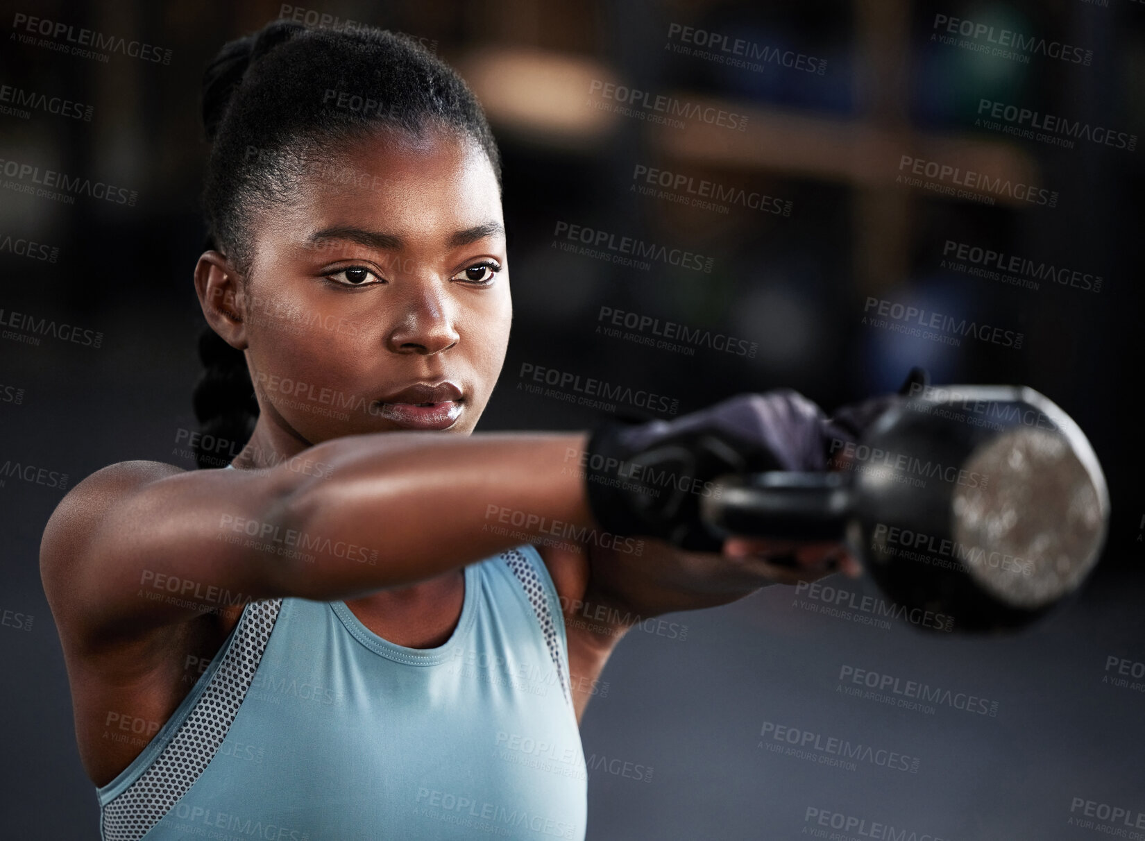 Buy stock photo Shot of a woman working out with a kettle bell at the gym