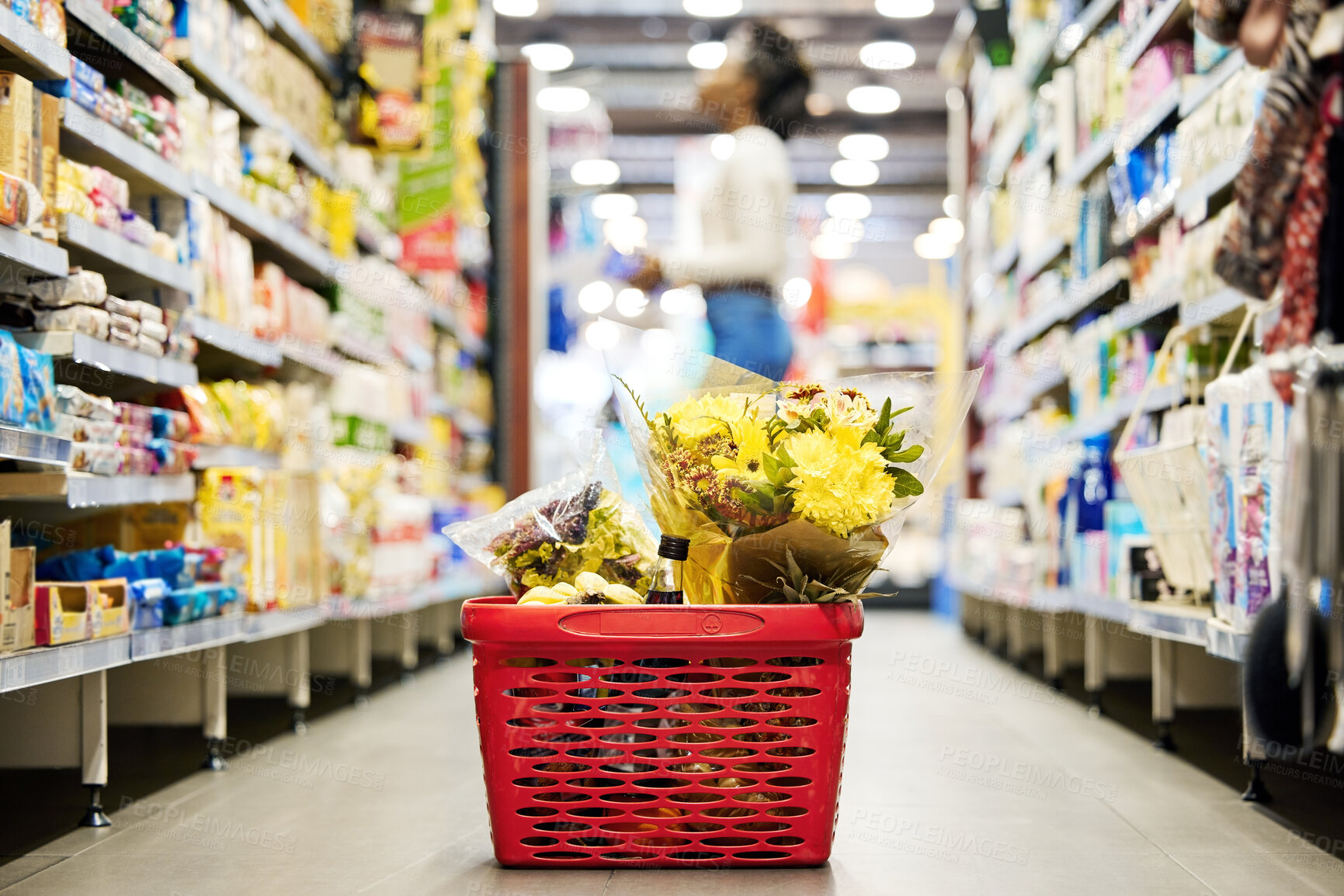 Buy stock photo Shopping basket, flowers and floor in grocery store on promotion, sale or gift with woman for customer experience. Plastic container, supermarket and mall for retail, plants and trading for choice