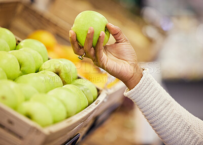Buy stock photo Shot of a woman surveying the apples in a grocery store