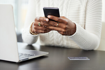 Buy stock photo Shot of a woman using her smartphone while making online card payments