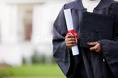 Buy stock photo Closeup shot of an unrecognisable woman holding a certificate and cap on graduation day