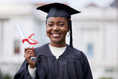 Buy stock photo Portrait of a young woman holding her diploma on graduation day