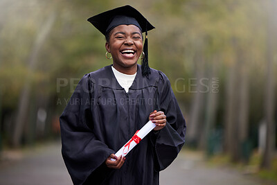 Buy stock photo Portrait of a young woman holding her diploma on graduation day